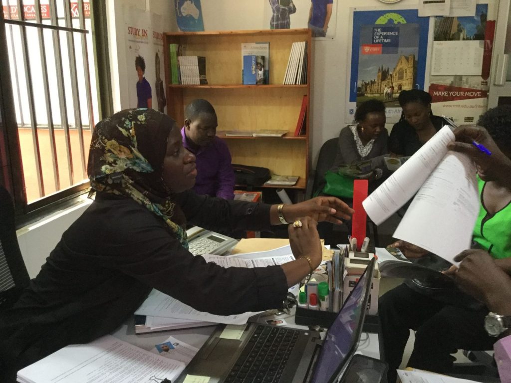 Students completing application forms at AEC Uganda