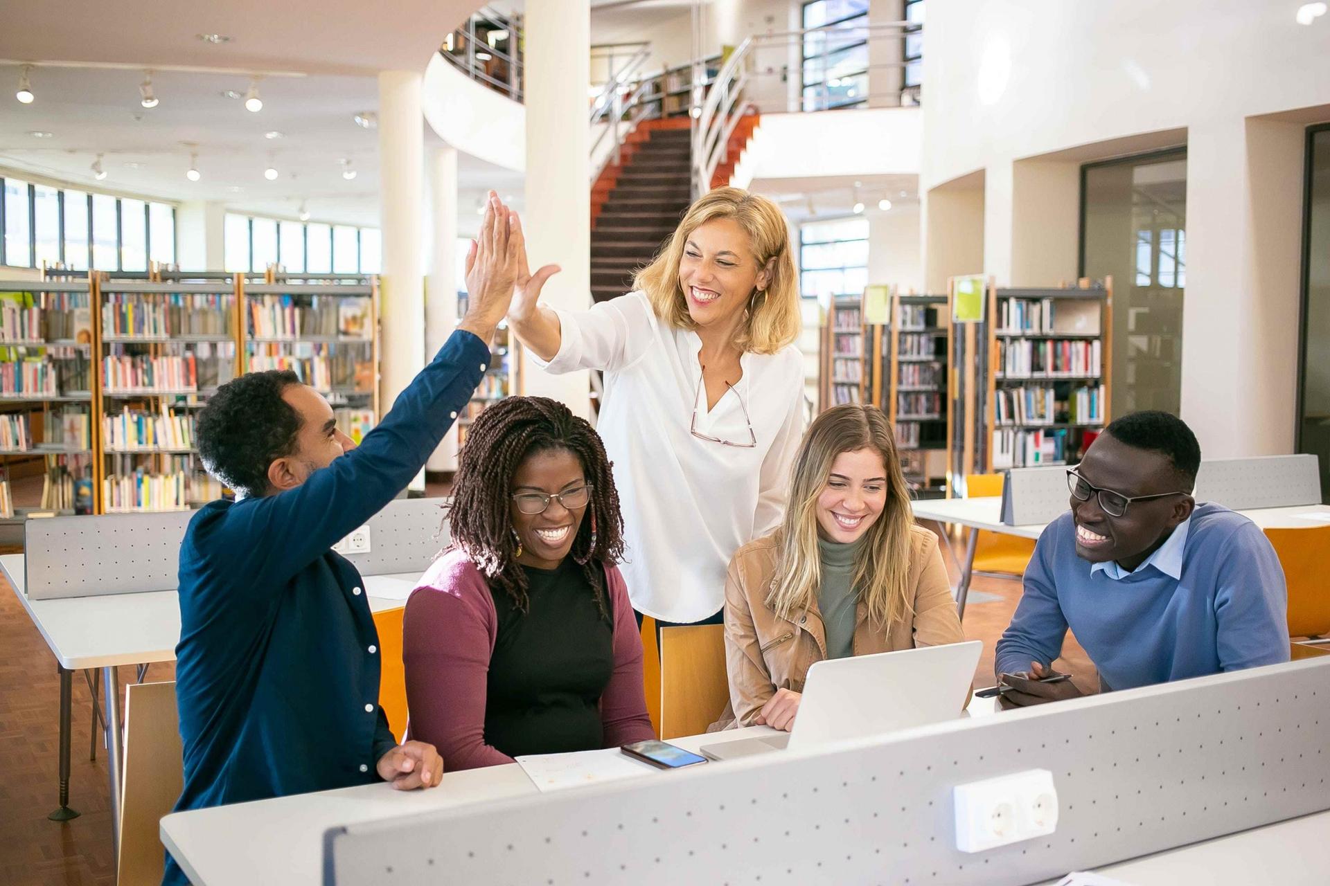 International students celebrating together in a university library in Australia